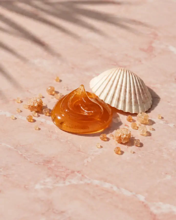 Still life: sugar paste and a seashell on pink marble