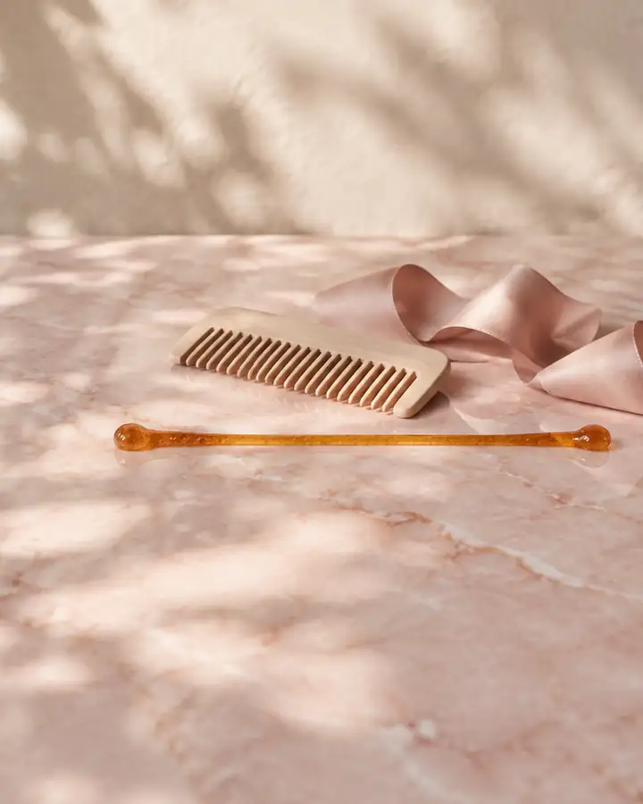 Still life: a fine line of sugar paste beside a comb and ribbon