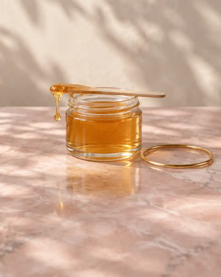Still life: a small jar of sugar paste and a gold bangle