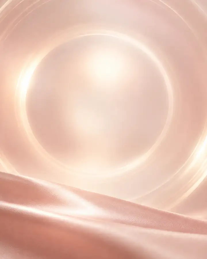 Still life: a soft ring of light above pink satin